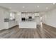 A well-lit open-concept kitchen features white cabinets, stainless appliances, and a kitchen island at 268 Onset Way, Westfield, IN 46074
