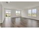 Bright living room with hardwood-style floors, large windows, and a sliding door to outdoor space at 268 Onset Way, Westfield, IN 46074
