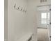 Functional mudroom with built-in bench, coat hooks, and a view to an adjacent room at 268 Onset Way, Westfield, IN 46074