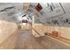 The unfinished attic space has exposed beams and some natural light at 2709 S Mcclure St, Indianapolis, IN 46241