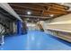 The unfinished basement with painted floor has laundry and work bench at 2709 S Mcclure St, Indianapolis, IN 46241