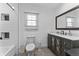 Modern bathroom featuring stylish vanity, a tiled shower, and a large mirror at 2709 S Mcclure St, Indianapolis, IN 46241