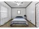 This cozy bedroom features a ceiling fan, wood-trimmed walls and a window for natural light at 2709 S Mcclure St, Indianapolis, IN 46241