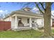 Charming home featuring a welcoming front porch with bench seating and a well-maintained lawn at 2709 S Mcclure St, Indianapolis, IN 46241