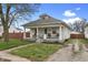 Charming home featuring a welcoming front porch with bench seating and a well-maintained lawn at 2709 S Mcclure St, Indianapolis, IN 46241