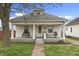 Charming home featuring a welcoming front porch with bench seating and a well-maintained lawn at 2709 S Mcclure St, Indianapolis, IN 46241