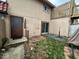 Back yard featuring a private back entrance, a sliding glass door, and green space at 2765 Del Prado Dr # 7, Indianapolis, IN 46227