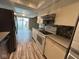 Clean kitchen features white appliances and cabinets, tile backsplash, and sliding door to backyard at 2765 Del Prado Dr # 7, Indianapolis, IN 46227