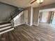 Spacious living room with staircase featuring wood-look tile flooring at 2765 Del Prado Dr # 7, Indianapolis, IN 46227