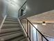 Staircase featuring a black metal railing and gray-toned steps at 2765 Del Prado Dr # 7, Indianapolis, IN 46227