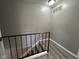 Second-floor staircase landing with gray walls and wood-look flooring at 2765 Del Prado Dr # 7, Indianapolis, IN 46227