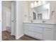 Bright bathroom featuring a double sink vanity, framed mirror, and wood look flooring at 3308 Morab Dr, Zionsville, IN 46077