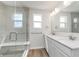 Modern bathroom featuring dual sinks, quartz counters, and a glass enclosed shower at 3308 Morab Dr, Zionsville, IN 46077