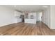 Open floor plan with hardwood floors connecting living, dining, and kitchen areas for seamless flow at 3308 Morab Dr, Zionsville, IN 46077