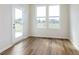 Bright room featuring wood-style flooring, large windows, and a door to the outside at 3308 Morab Dr, Zionsville, IN 46077