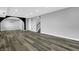 Finished basement with gray wood floors, recessed lighting, and an arched doorway at 3701 Dorval Pl, Indianapolis, IN 46228