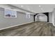 Finished basement with gray wood floors, recessed lighting, and windows at 3701 Dorval Pl, Indianapolis, IN 46228