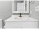 A bright bathroom featuring a white vanity and marble countertop with an elegant bronze faucet at 3701 Dorval Pl, Indianapolis, IN 46228