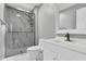 Bright bathroom featuring tiled shower and floors, glass doors, and a white vanity with bronze fixtures at 3701 Dorval Pl, Indianapolis, IN 46228