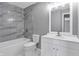 Updated bathroom with tub and shower, and modern vanity at 3701 Dorval Pl, Indianapolis, IN 46228