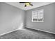 Simple bedroom with carpeting and a large window overlooking the neighborhood at 3701 Dorval Pl, Indianapolis, IN 46228
