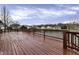 Large wooden deck overlooking a tranquil lake providing a peaceful outdoor retreat at 3701 Dorval Pl, Indianapolis, IN 46228