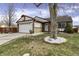 Charming home showcasing well-manicured lawn, flower bed, and a welcoming front entrance at 3701 Dorval Pl, Indianapolis, IN 46228