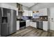 Modern kitchen with stainless steel appliances, white cabinetry, and a stylish tile backsplash at 3701 Dorval Pl, Indianapolis, IN 46228