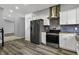 Contemporary kitchen with stainless steel appliances, white cabinets, and wood countertops, offering a modern aesthetic at 3701 Dorval Pl, Indianapolis, IN 46228