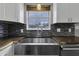 Stylish, modern kitchen sink featuring a large window and sleek faucet for a bright, functional workspace at 3701 Dorval Pl, Indianapolis, IN 46228