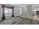 Inviting living room with hardwood floors, large window, and views into the kitchen at 3701 Dorval Pl, Indianapolis, IN 46228