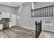 Bright living room with hardwood floors, modern light fixture, and view of kitchen with stainless steel appliances at 3701 Dorval Pl, Indianapolis, IN 46228