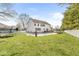 Expansive backyard featuring a swimming pool, trampoline, and a white picket fence at 3998 Jonathan Rdg, Columbus, IN 47201