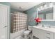 Full bathroom featuring a tub and shower combination with a vanity and decorative red flowers at 3998 Jonathan Rdg, Columbus, IN 47201