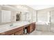 Bright primary bathroom with double sinks, soaking tub, and walk-in closet at 3998 Jonathan Rdg, Columbus, IN 47201
