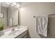 Neutral toned bathroom with marble countertop and oval mirror above a sink with a silver faucet at 3998 Jonathan Rdg, Columbus, IN 47201
