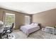 Bedroom with large windows, an area rug, desk and chair, and a neatly made bed at 3998 Jonathan Rdg, Columbus, IN 47201