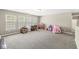 Spacious bonus room featuring neutral carpet, a closet, and lots of natural light from three windows at 3998 Jonathan Rdg, Columbus, IN 47201