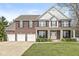 Charming brick two-story home with a three-car garage and inviting front porch at 3998 Jonathan Rdg, Columbus, IN 47201