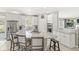 Modern white kitchen featuring a granite island and stainless steel appliances at 3998 Jonathan Rdg, Columbus, IN 47201