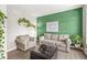 Cozy living room featuring comfortable seating and a vibrant green accent wall at 3998 Jonathan Rdg, Columbus, IN 47201