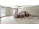 Large main bedroom featuring neutral walls, and carpet, with two windows and an accent trunk at the foot of the bed at 3998 Jonathan Rdg, Columbus, IN 47201