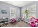 Playroom featuring hardwood floors, three windows and blue painted walls with various toys and furniture at 3998 Jonathan Rdg, Columbus, IN 47201