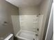 The bathroom includes a standard bathtub and shower with storage shelves at 4047 Biscayne Rd, Indianapolis, IN 46226