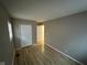A well-lit bedroom showcasing wood-look flooring, neutral walls, and a window at 4047 Biscayne Rd, Indianapolis, IN 46226