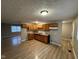 Kitchen featuring wooden cabinets, laminate flooring, and a new countertop at 4047 Biscayne Rd, Indianapolis, IN 46226