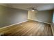 Spacious living room featuring new laminate floors, fresh paint, and a ceiling fan at 4047 Biscayne Rd, Indianapolis, IN 46226