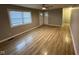 Bright living room with laminate floors, a ceiling fan, and natural light from the window at 4047 Biscayne Rd, Indianapolis, IN 46226