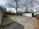 Backyard view showcasing a detached garage and a gravel parking area for additional vehicles or storage at 4224 N Arlington Ave, Indianapolis, IN 46226