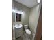Half bath featuring a vanity with a sink and a toilet with neutral paint at 4224 N Arlington Ave, Indianapolis, IN 46226